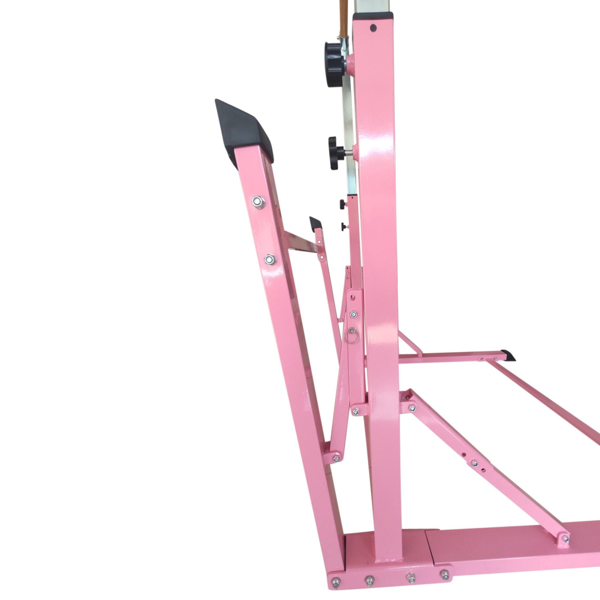 Pink folding gymnastics bar set up indoors for home training.