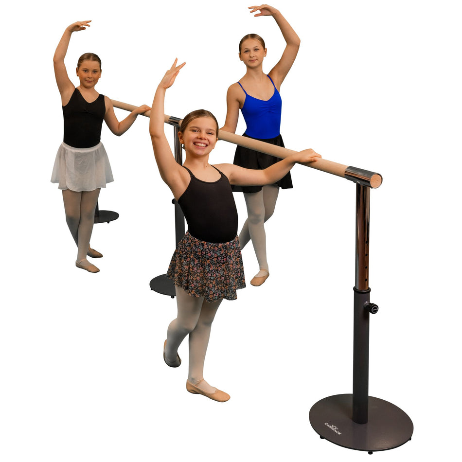 Three individuals posing with a freestanding and portable ballet barre which is black in color, with a main barre and an extension included.