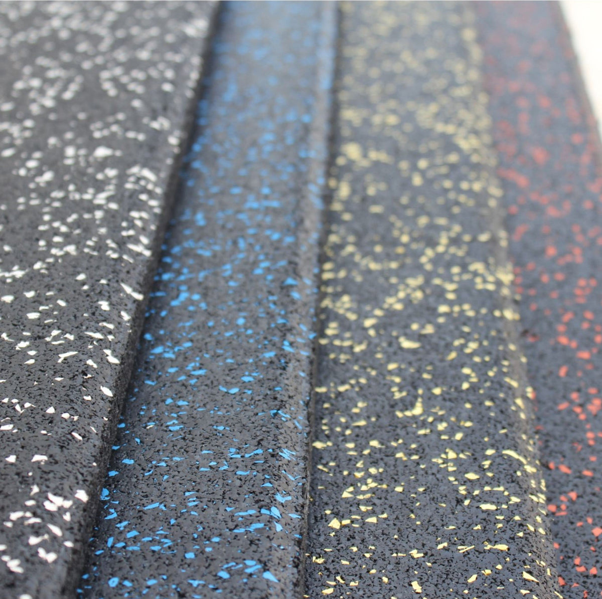Layered edge comparison of four coloured gym floor tiles