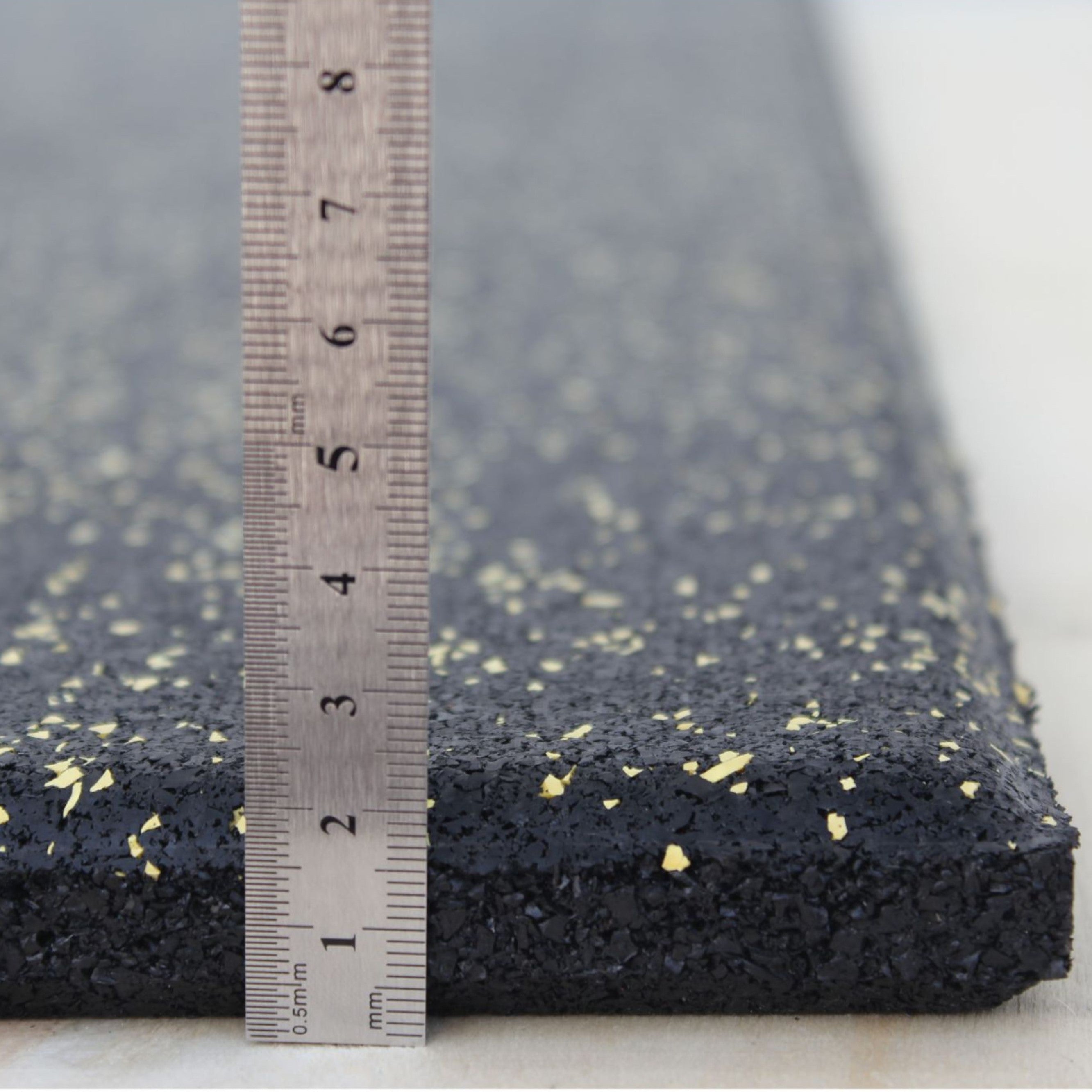 Yellow fleck rubber tile thickness shown from side