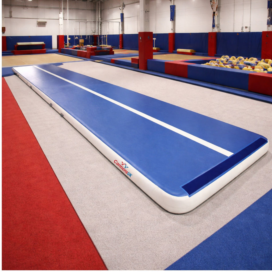 Gymnastics training facility with a large inflatable track and colorful equipment.