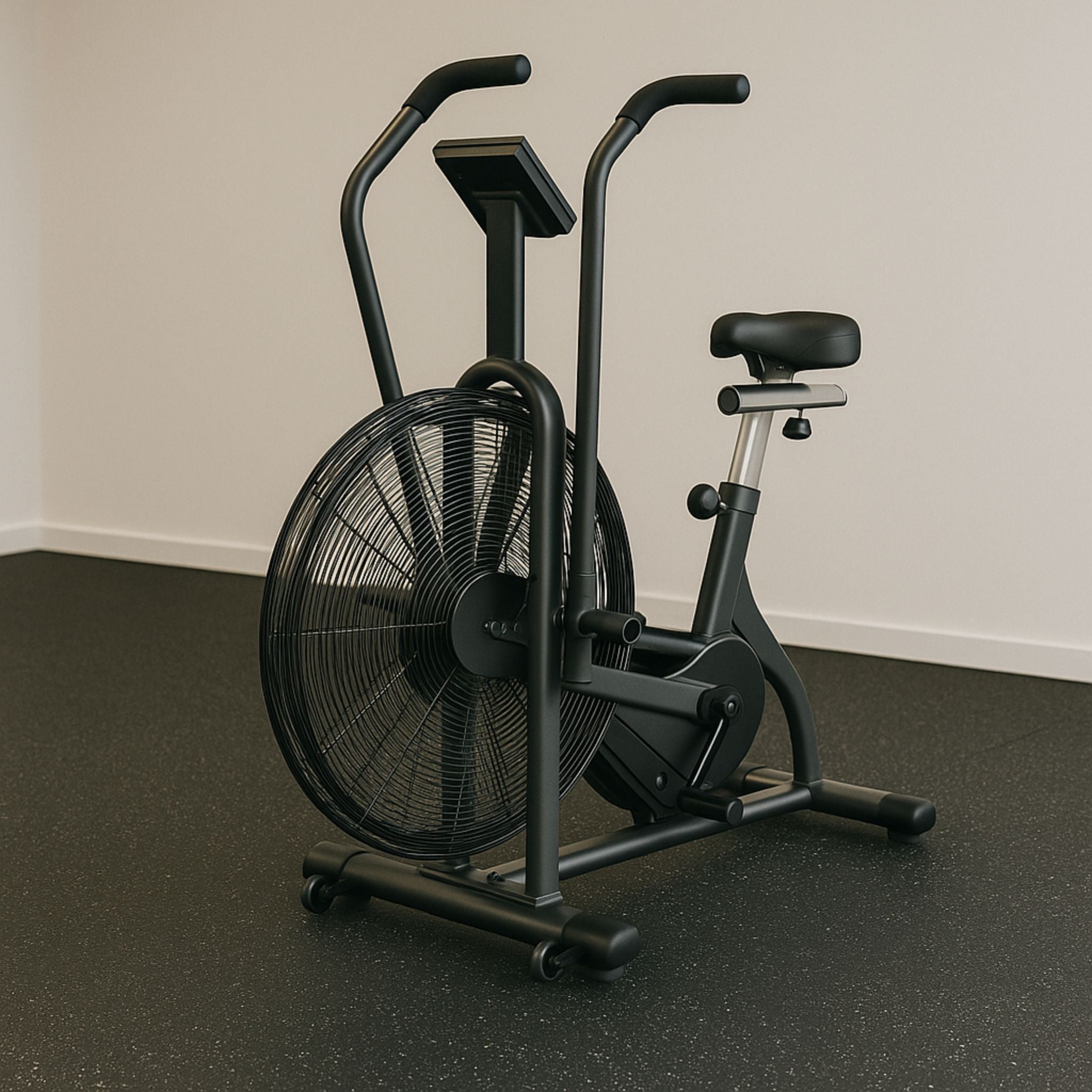 Stationary air bike on speckled rubber flooring in a minimalist gym space.