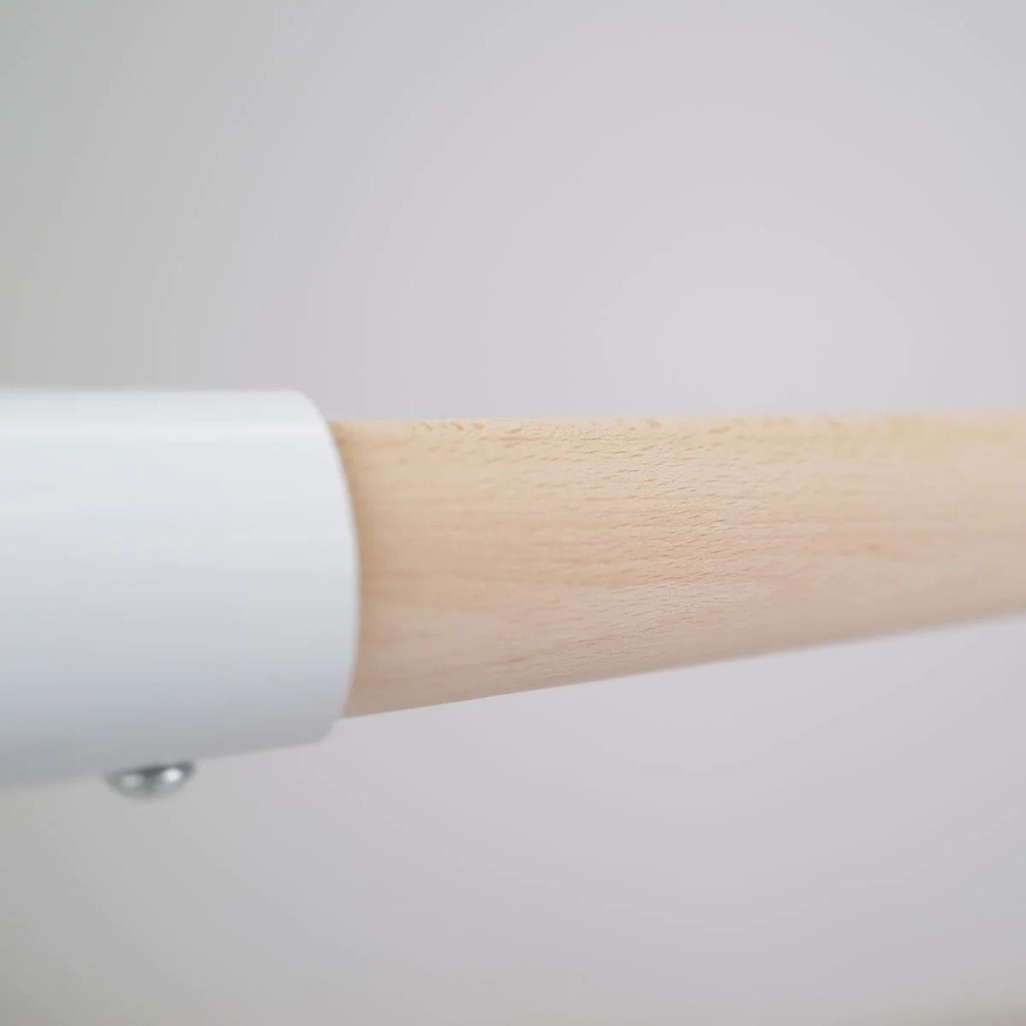 White 110 cm barre against concrete wall  
