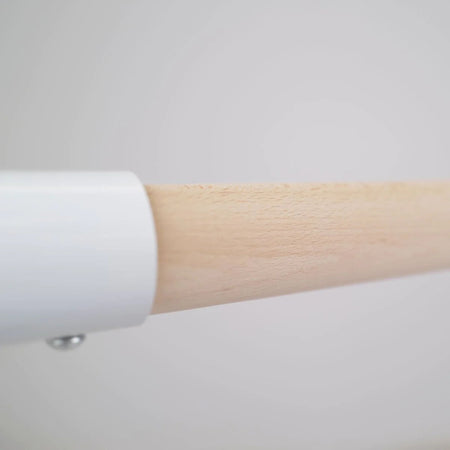 White 110 cm barre against concrete wall  
