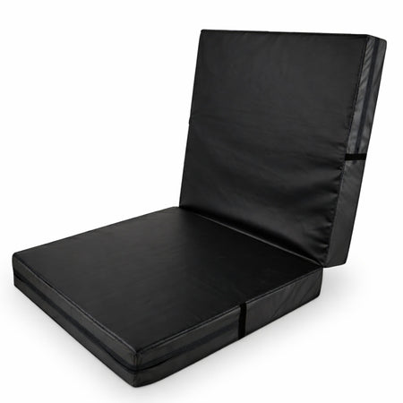 Black bi-fold gymnastics crash mat standing upright, thick foam core and wipe-clean vinyl cover by Cannons UK