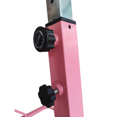 Close-up of adjustment knobs and holes on pink Cannons UK gymnastics bar.
