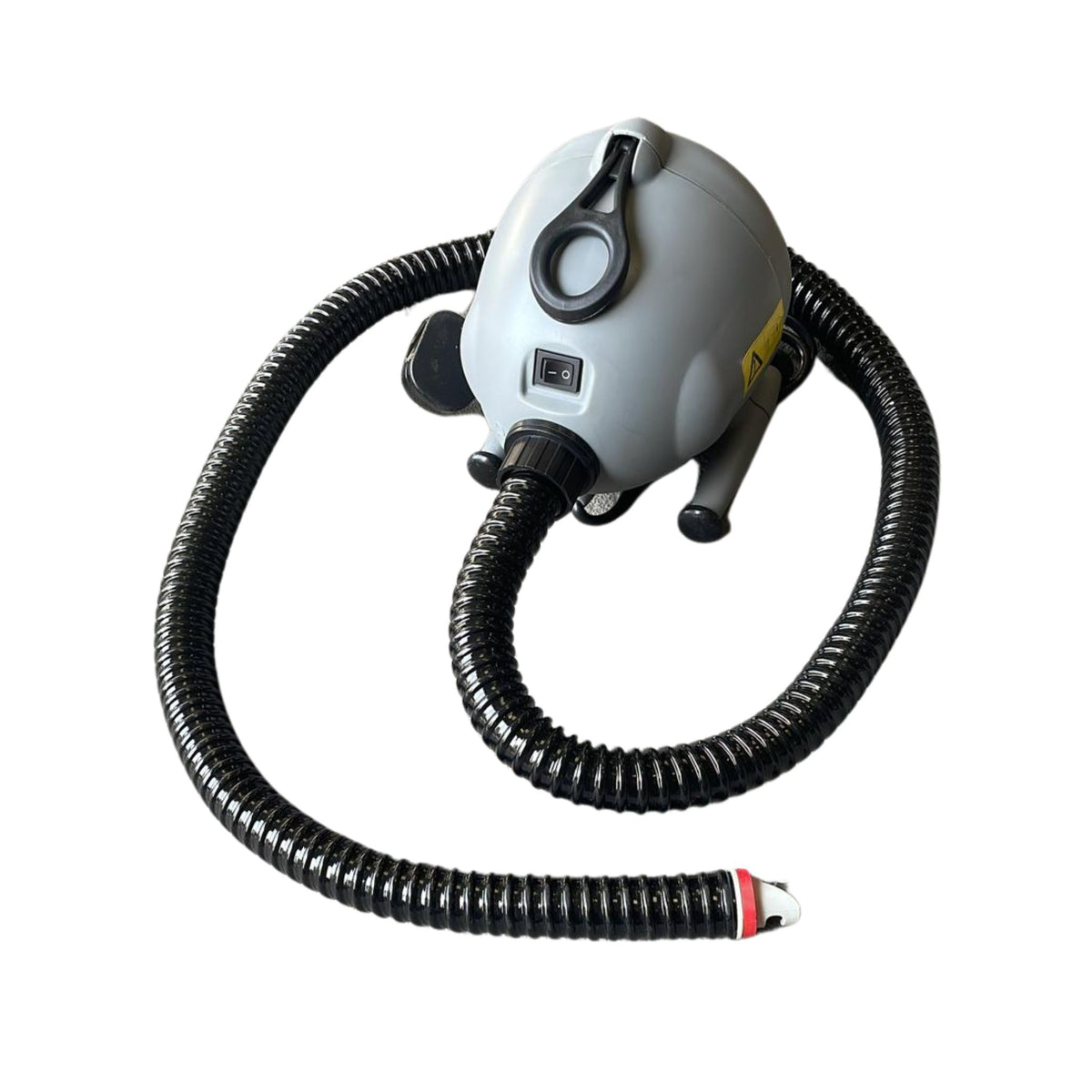An electric blower with a grey body, black hose, and red valve, designed for inflating air tracks.