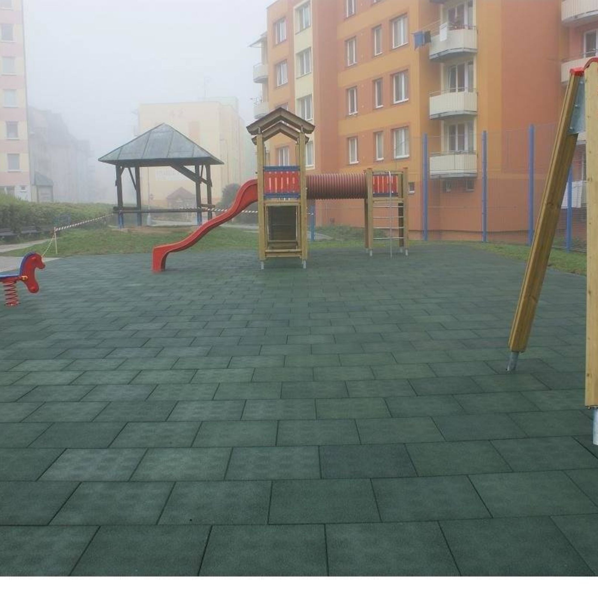 Installed green tiles — courtyard/gazebo area; tight joints, flat surface.