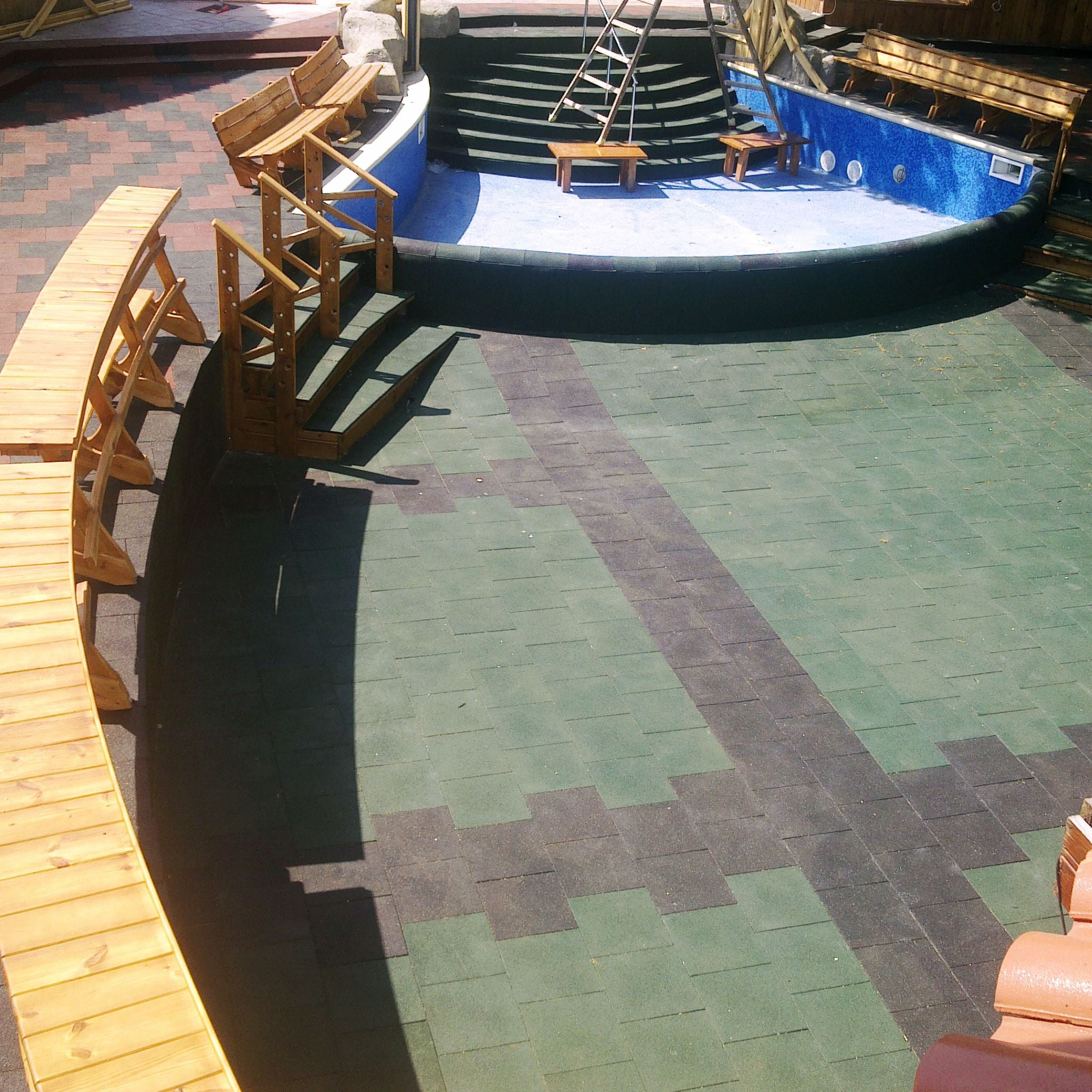 Installed green tiles — pool/curved edge; non-slip, neat perimeter.