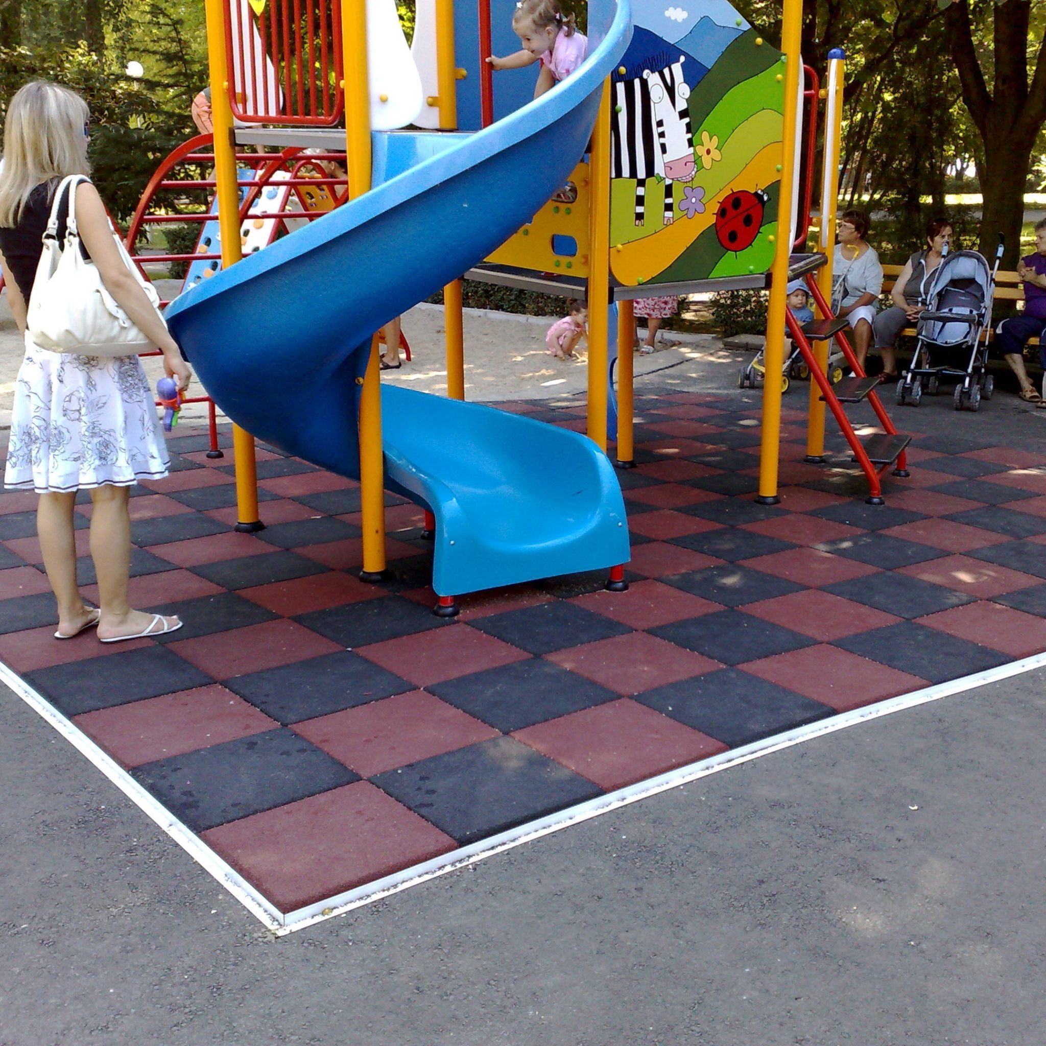 Installed red & black checker tiles at slide bay — shock-absorbing safety surfacing.