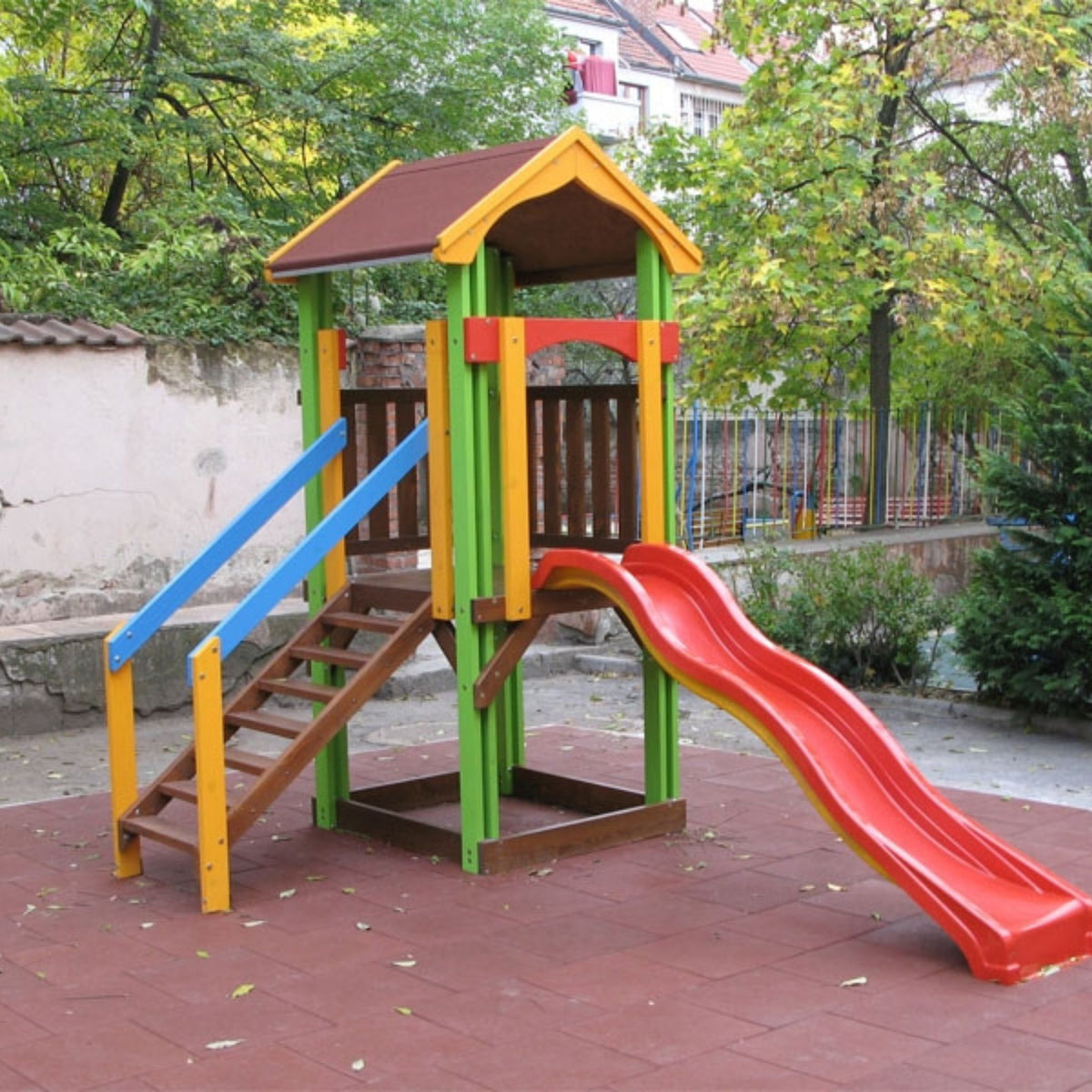 Installed red tiles — slide platform/run-out; stable footing.