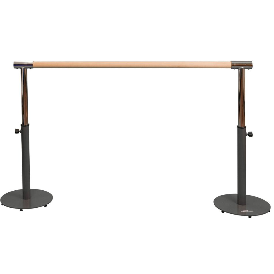 Two young girls using a black freestanding portable ballet barre with adjustable height, standing on a white background.