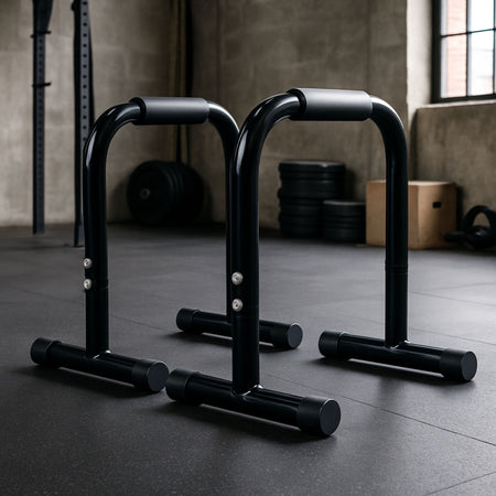 High parallel bars set up in a training studio with gym equipment in the background.