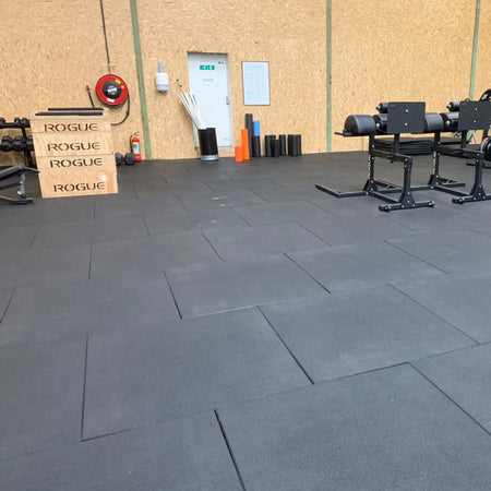 Flatline PRO grey flooring installed across gym floor beneath equipment  
