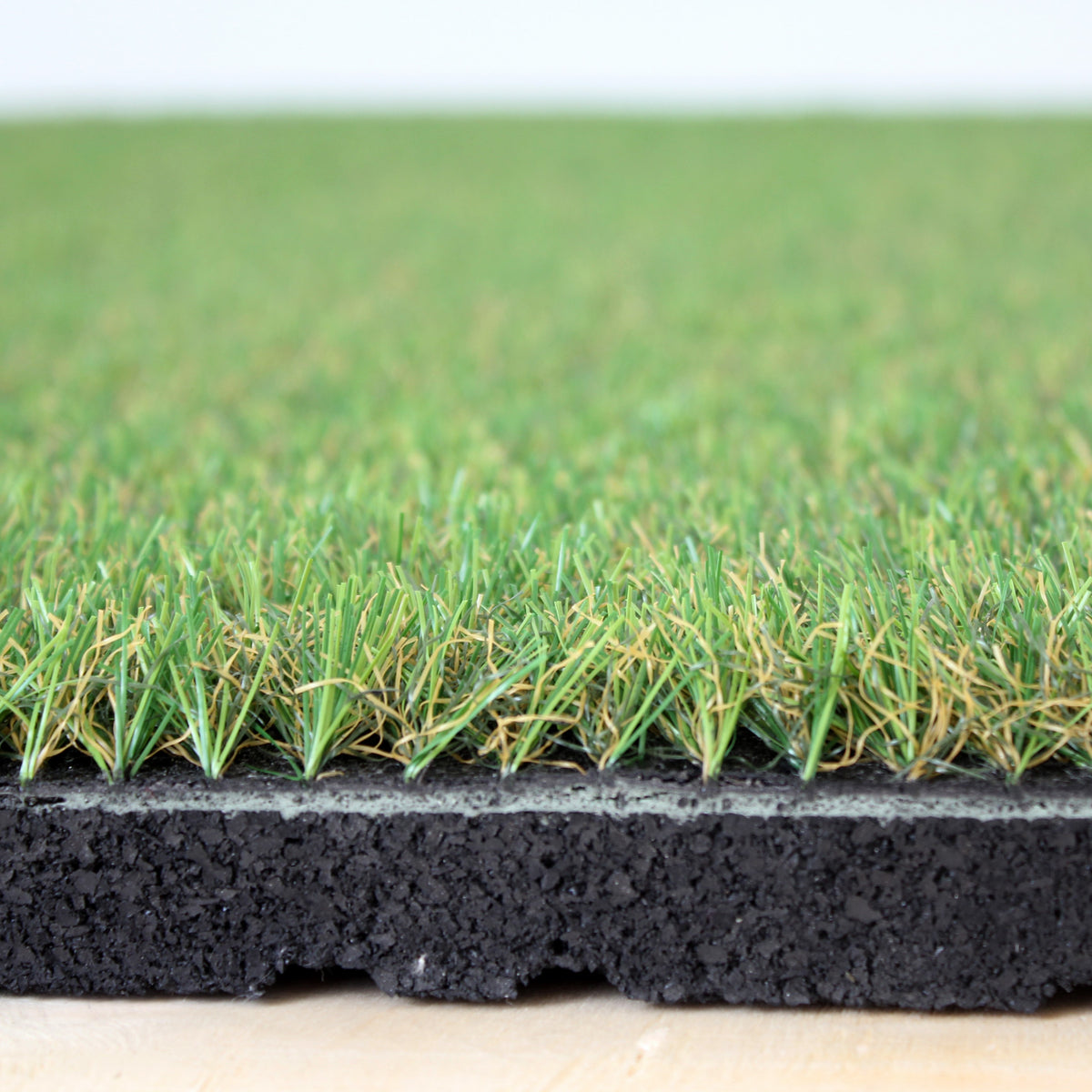 Angled studio shot of artificial grass floor tile  

