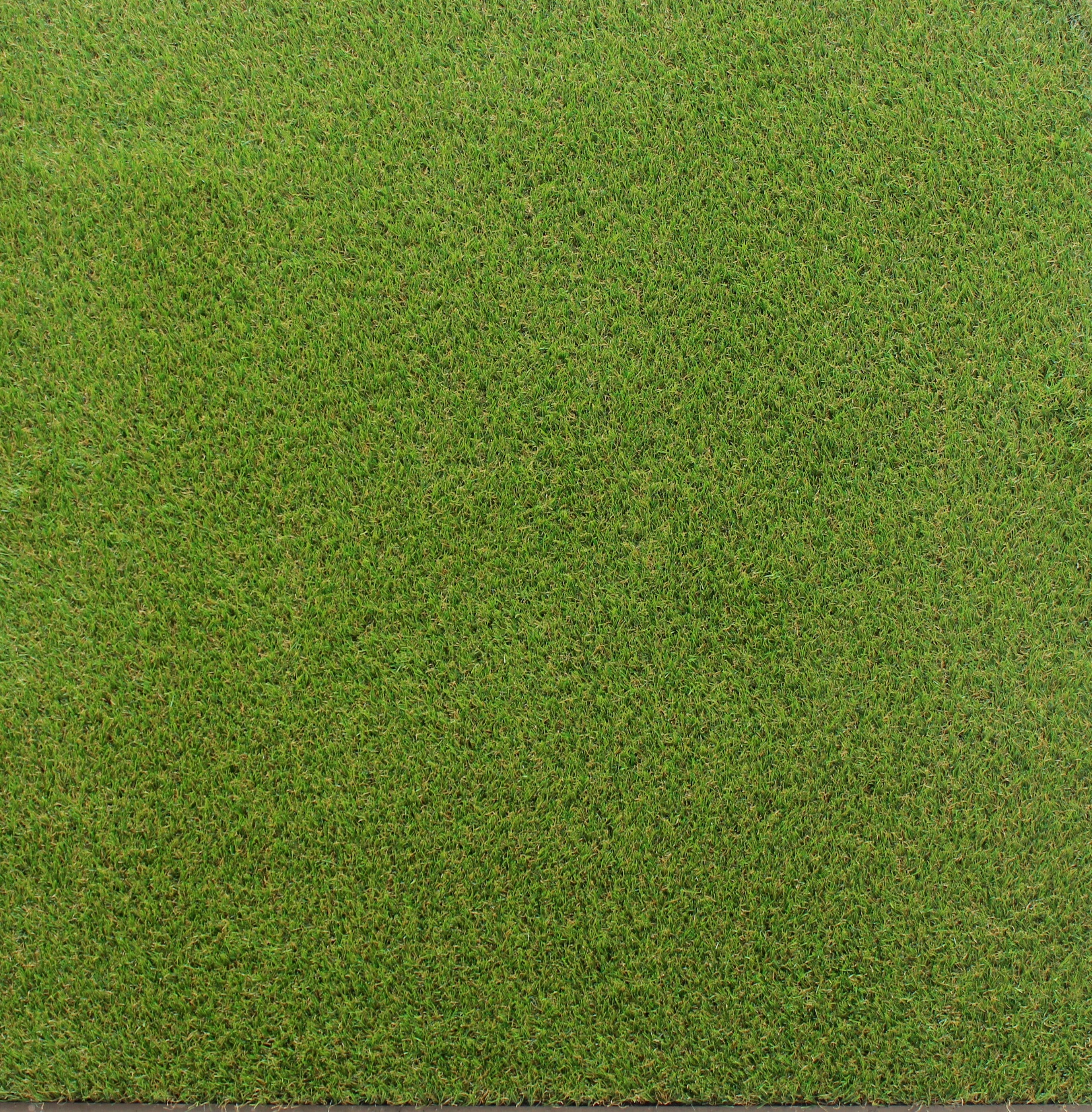 Artificial grass-topped rubber floor tile – top-down product view  
