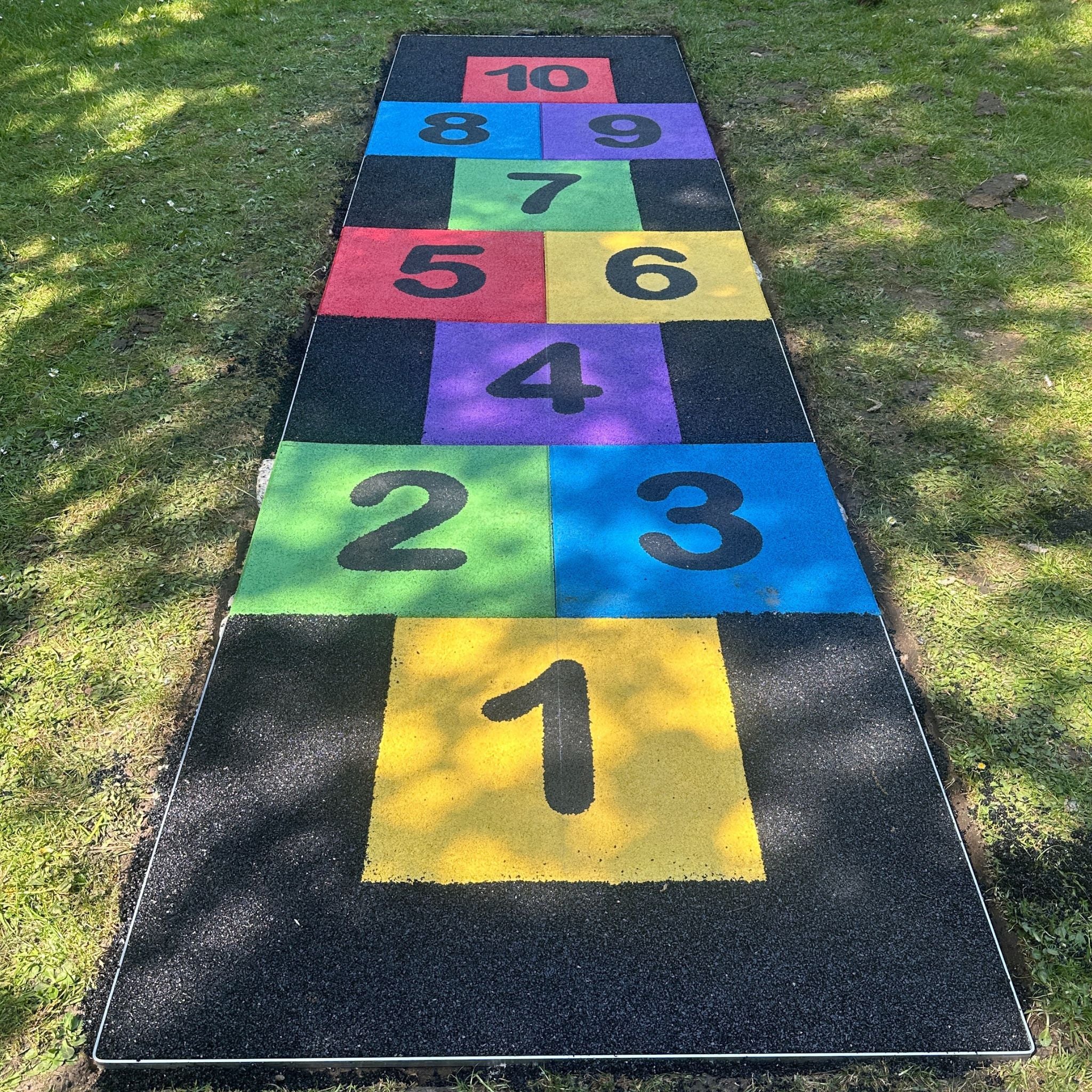Colorful hopscotch mat on grass
