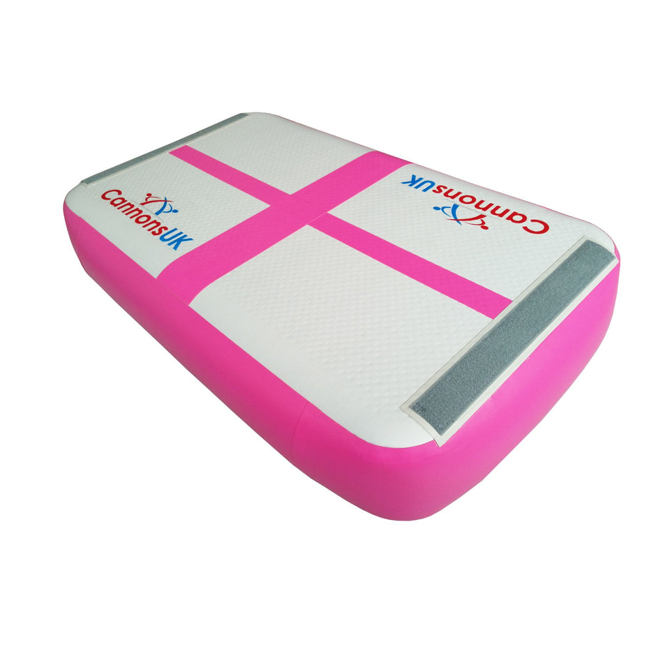 Cannons UK Air Track Pro Air Block (pink) — isometric hero on white showing 1m × 60cm × 20cm size, cross marker, rounded corners and smooth landing surface