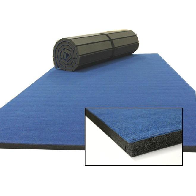 12 m rollaway mat, carpet top blue — rolled-open hero with corner cross-section inset; ideal for gymnastics, wrestling, martial arts and PE. 