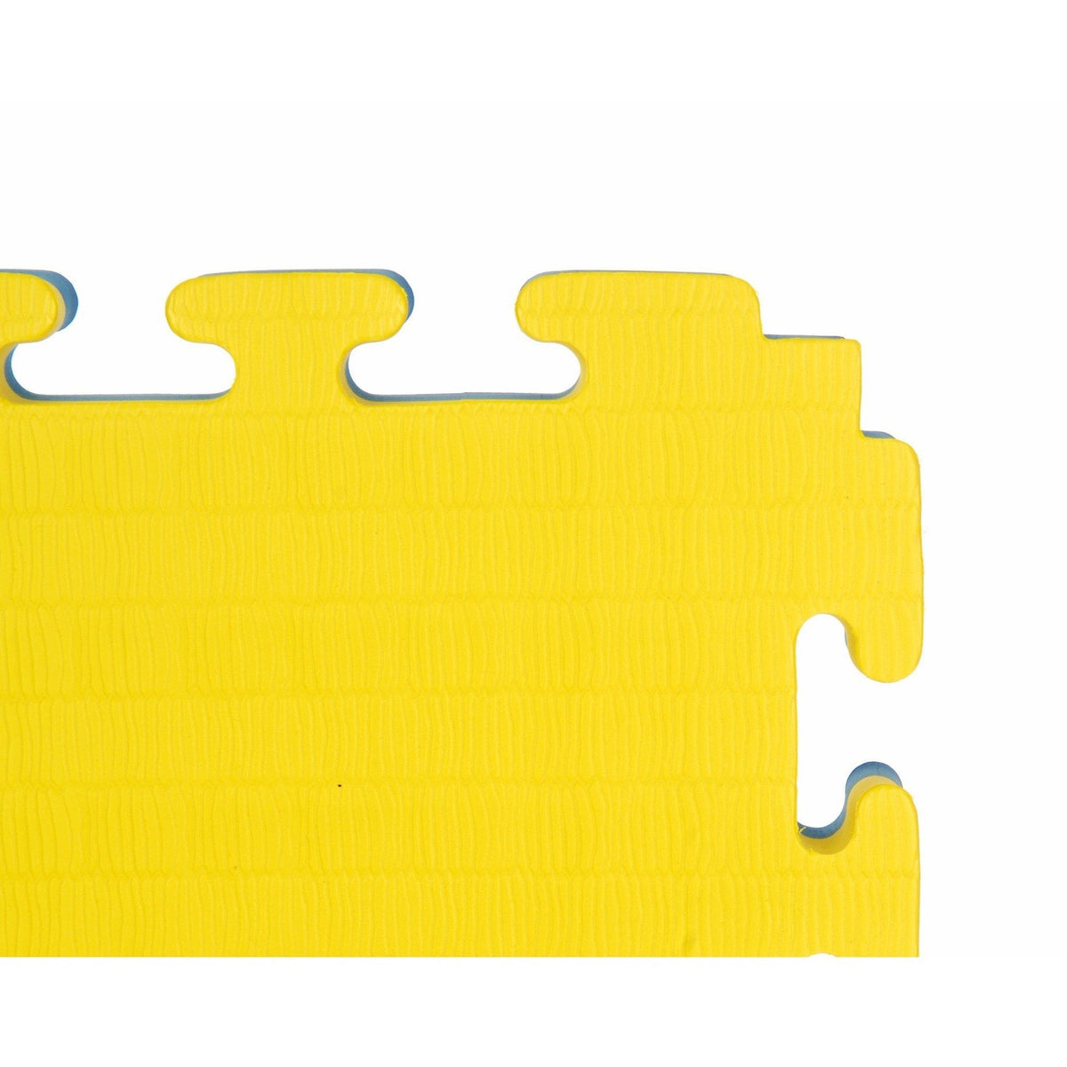 Close detail shot of a corner of reversible yellow/blue mat, showing foam layers and texture.