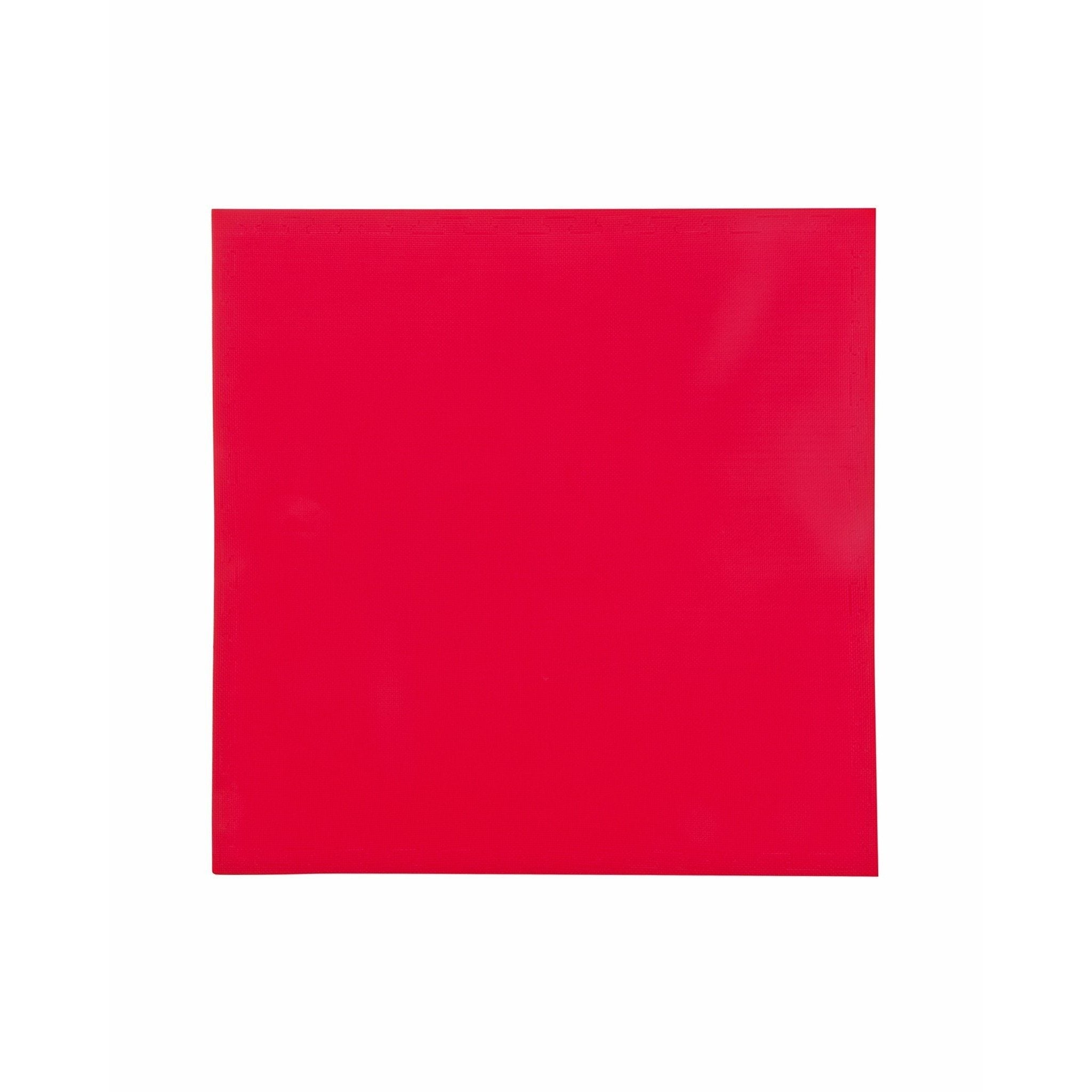 Angled edge shot of red and blue mat — interlocking teeth visible, profile of foam thickness.